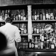 Old photo of a bartender behind a bar